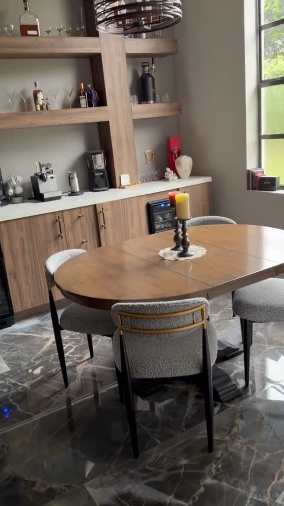 Finished dining area with custom wood built-ins, open shelving and tile flooring