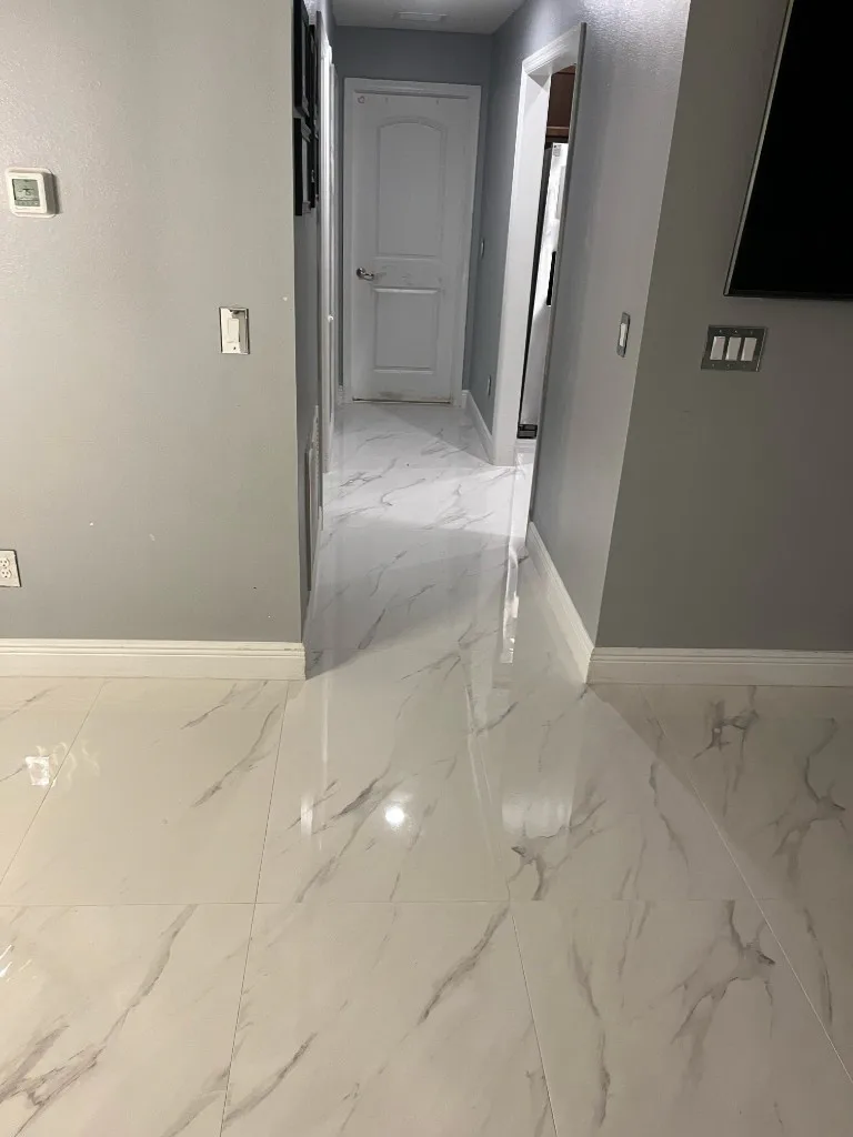 Polished marble-look tile flooring through a finished living area