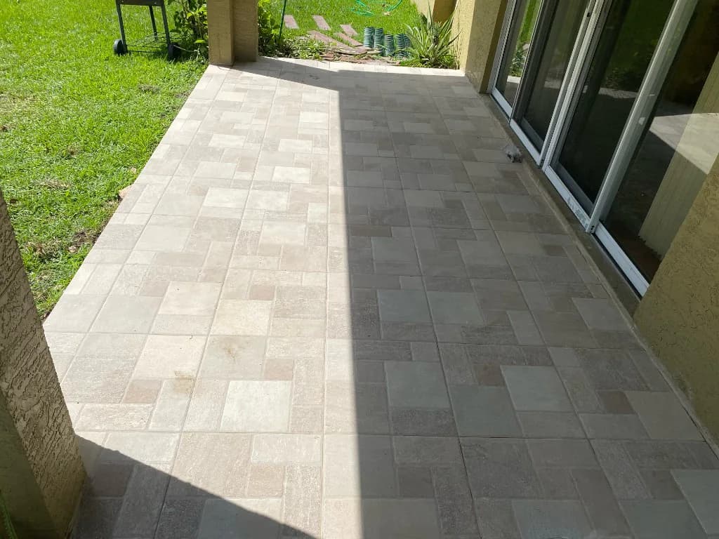 Finished covered patio paved in a multi-size rectangular pattern